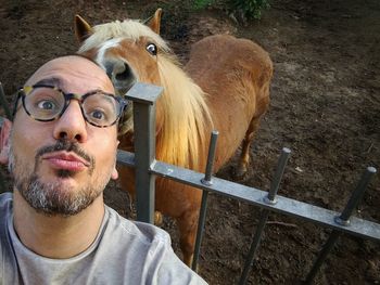 High angle view of man with horse at ranch