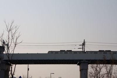 Low angle view of electricity pylon against sky