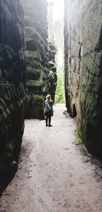 Rear view of man walking on rock