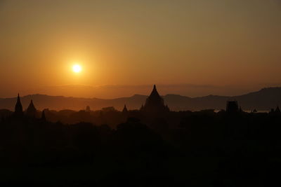 Silhouette of temple against sky during sunset