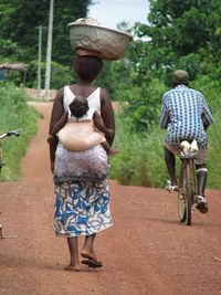 Rear view of people on road