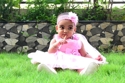 Portrait of cute girl sitting outdoors