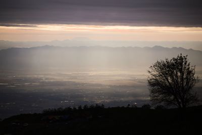 Scenic view of silhouette mountains against sky at sunset