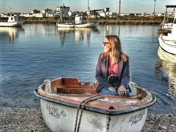 Woman sitting on boat in lake