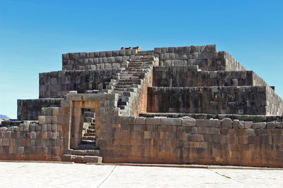 Old ruin building against blue sky