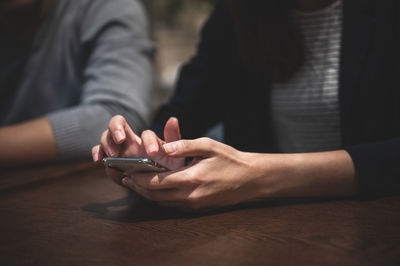 Midsection of woman using smart phone