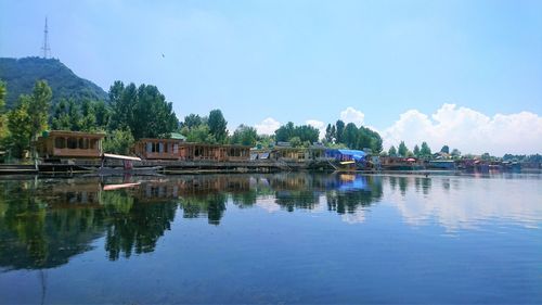 Scenic view of lake by trees against sky