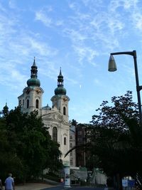 Trees and buildings against sky in city