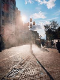 Street amidst buildings in city against sky