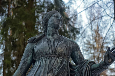 Low angle view of statue against trees