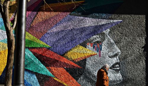 Low section of person standing on graffiti