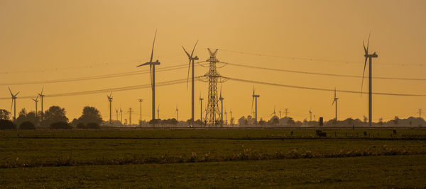 Wind turbines onshore wind farm on the north sea coast at sunset