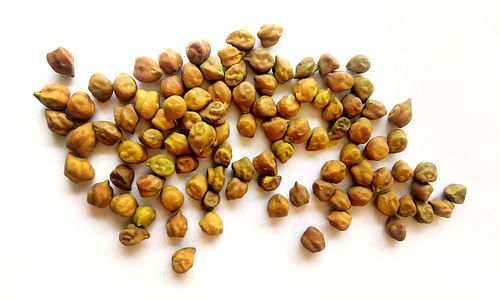 High angle view of coffee beans against white background