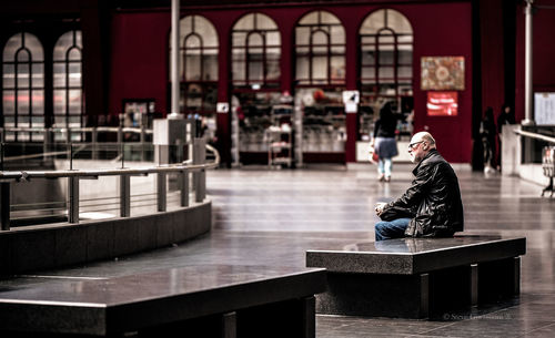 Woman sitting on bench in restaurant