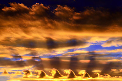 Low angle view of dramatic sky during sunset