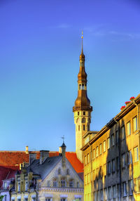 View of buildings against clear blue sky