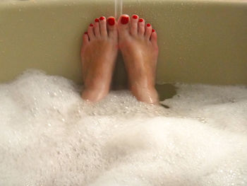 Low section of man relaxing on wet surface