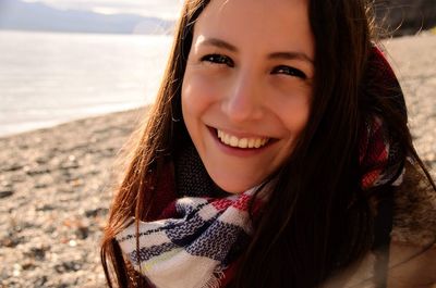 Close-up portrait of smiling woman at beach