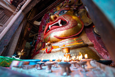 Low angle view of buddha statue against building