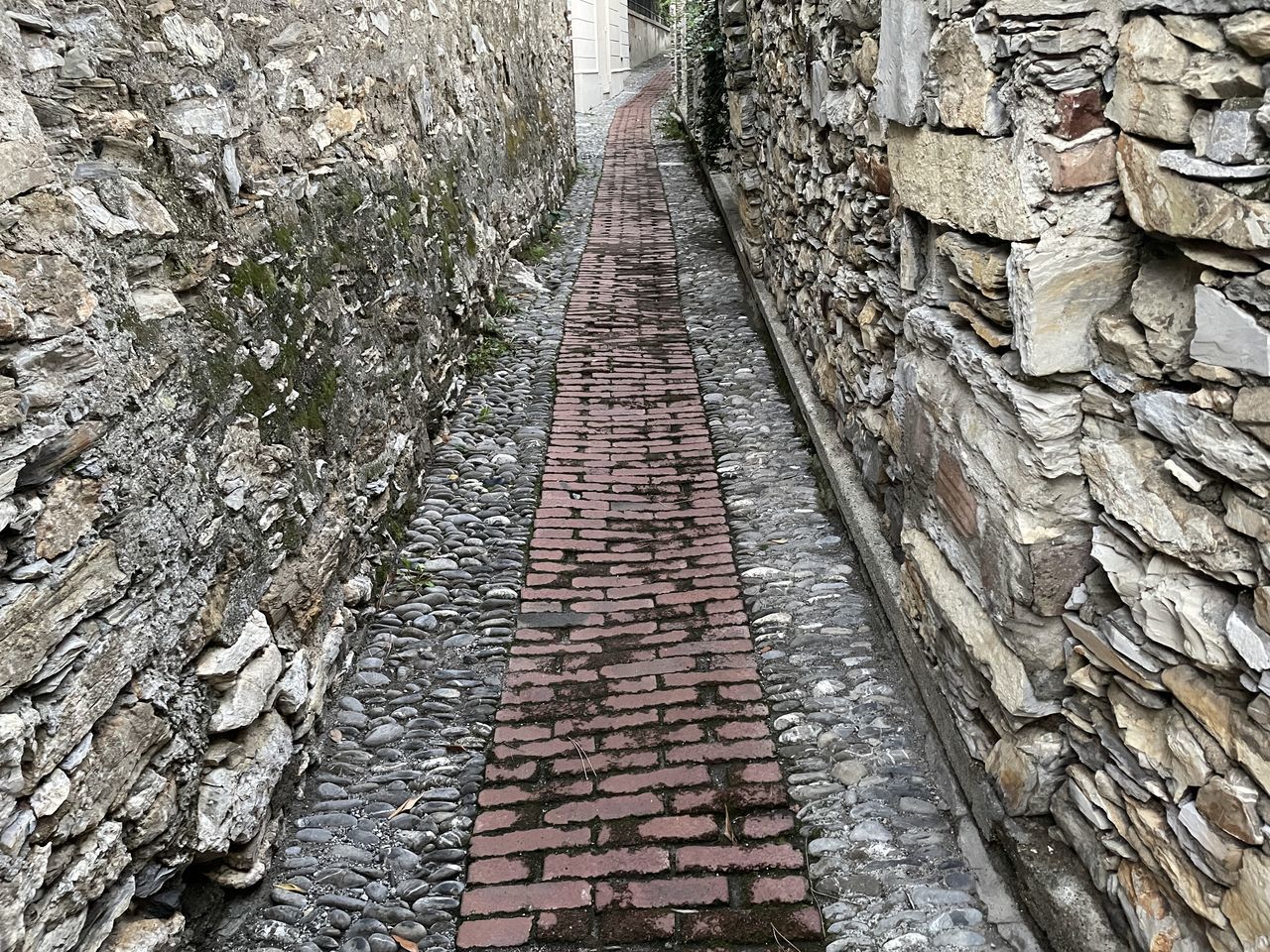 track, wall, architecture, no people, the way forward, day, built structure, outdoors, rock, nature, stone wall, railroad track, transport, high angle view, footpath, ancient history, diminishing perspective, cobblestone, wall - building feature, ruins, plant, walkway, rubble, rail transportation, road surface, old, tree, stone, transportation