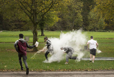 Men standing by tree