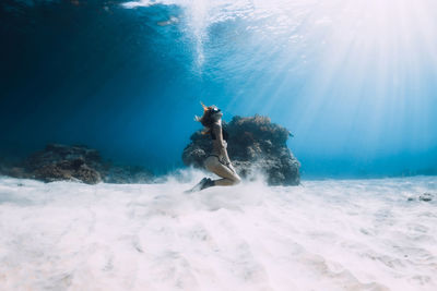 Rear view of woman standing on beach