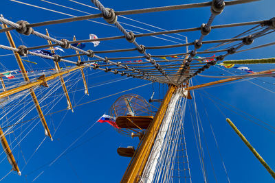 Low angle view of ferris wheel against blue sky