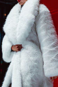 Fashion details of a white fluffy winter fur coat. winter women's casual fashion