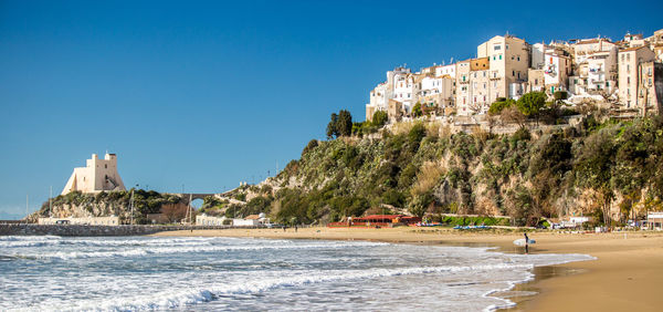 View of beach and buildings against sky