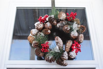 Close-up of christmas tree on window sill