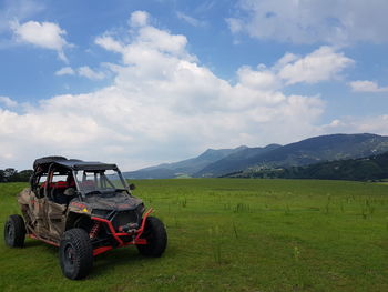 Tractor on field against sky