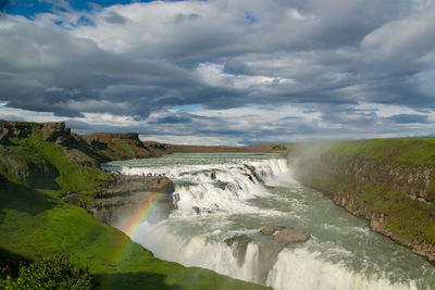 Scenic view of waterfall against sky