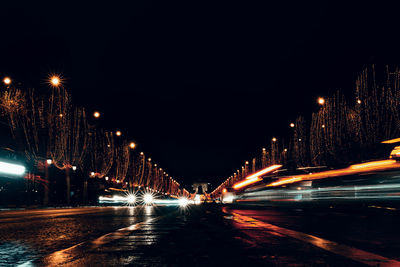 Illuminated light trails on street at night