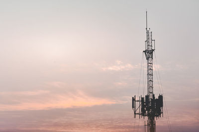 Low angle view of communications tower against sky during sunset