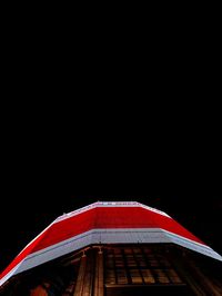 Low angle view of roof against clear sky at night