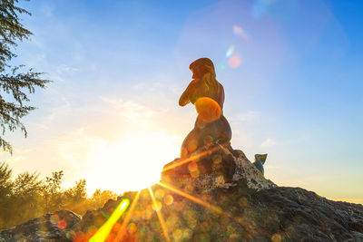 Low angle view of statue against sky during sunset