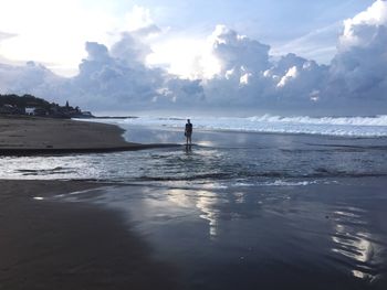 People on beach against sky