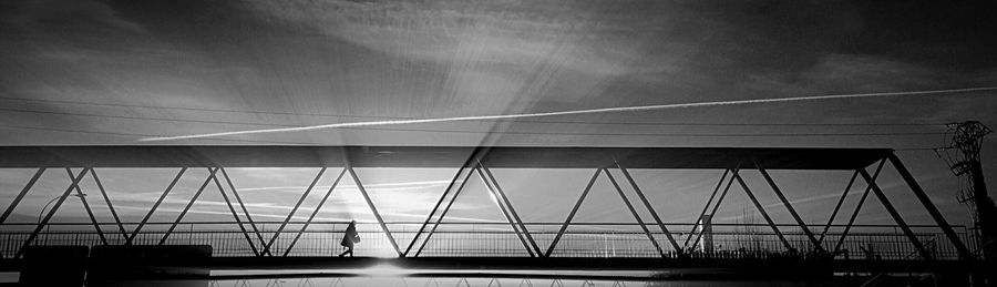 Low angle view of suspension bridge against sky