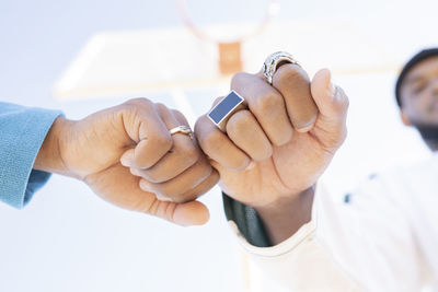 Male and female friend giving fist bump