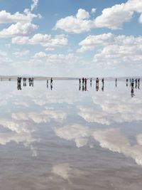 People on beach against sky