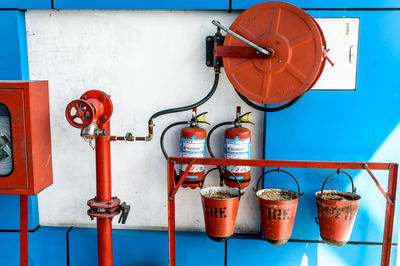 Close-up of fire hydrant against blue wall