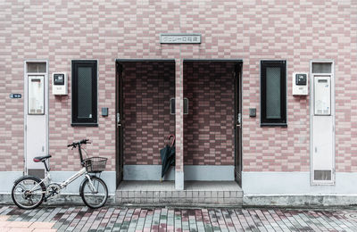 Bicycles on sidewalk against building