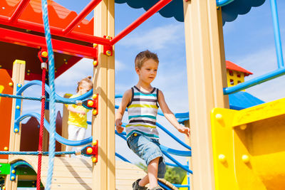 Boy playing on slide at playground