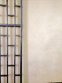 Close-up of ladder against wall