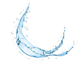 Close-up of water splashing against white background