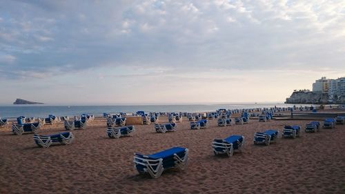 Scenic view of beach against cloudy sky