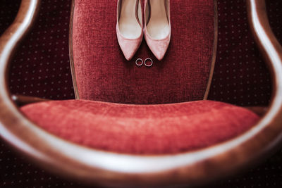 Low section of woman wearing red shoes
