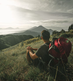 Rear view of man looking at view against sky