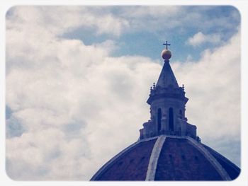 Low angle view of building against cloudy sky