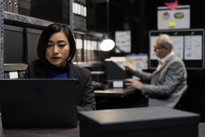 Businesswoman using laptop at table